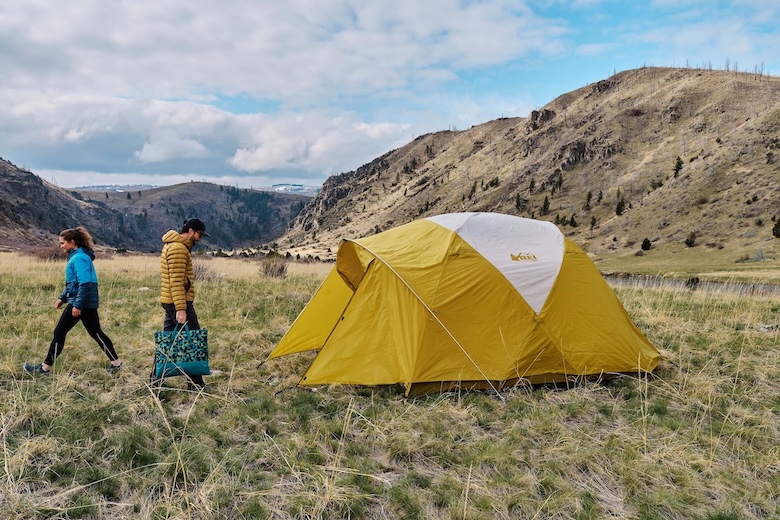 Setting up the REI Base Camp 6 tent in a field while camping in Montana