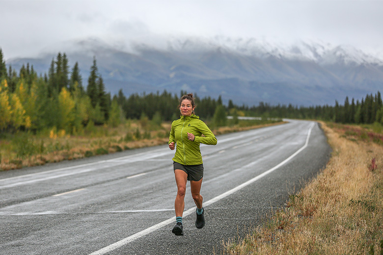 A woman running on a road in moody weather