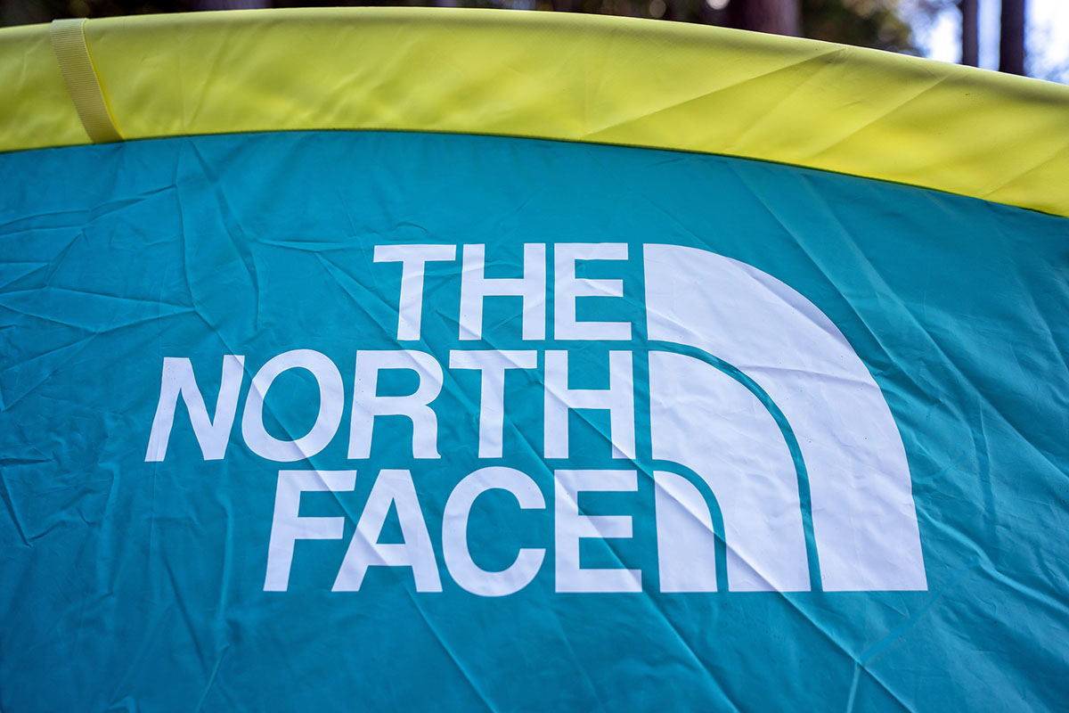 A prominent North Face logo on the side of a tent.