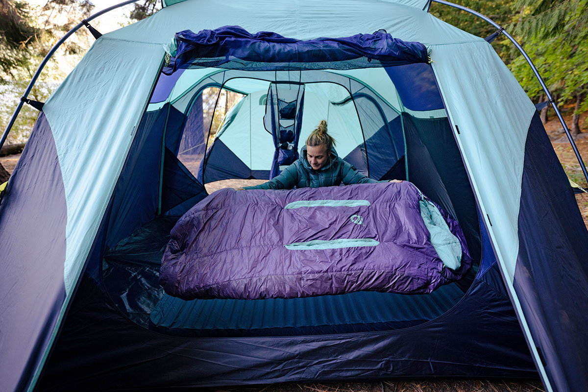 A hiker sets up a comfortable camping space with the Nemo sleeping bag.