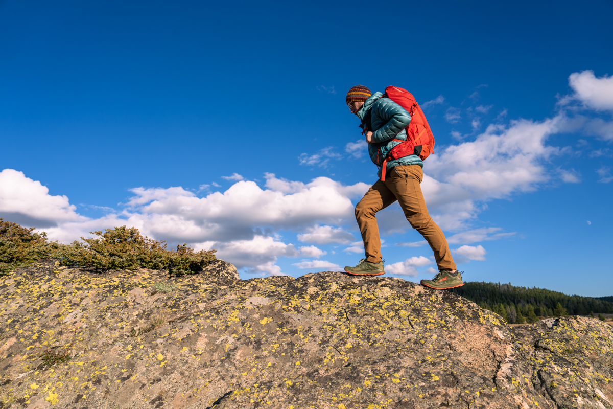 An intrepid adventurer traversing a rocky mountain spine in Wyoming.