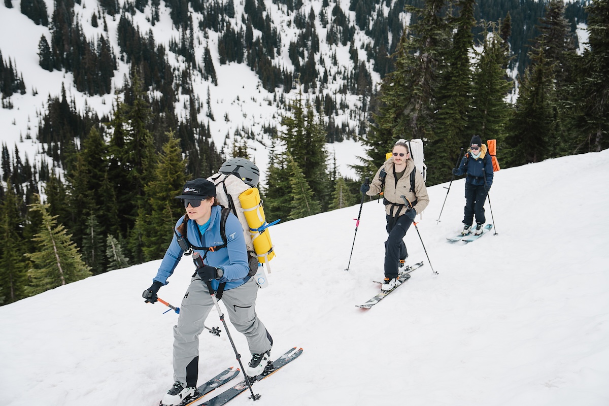 A trio of skiers ski tour up Mount Rainier