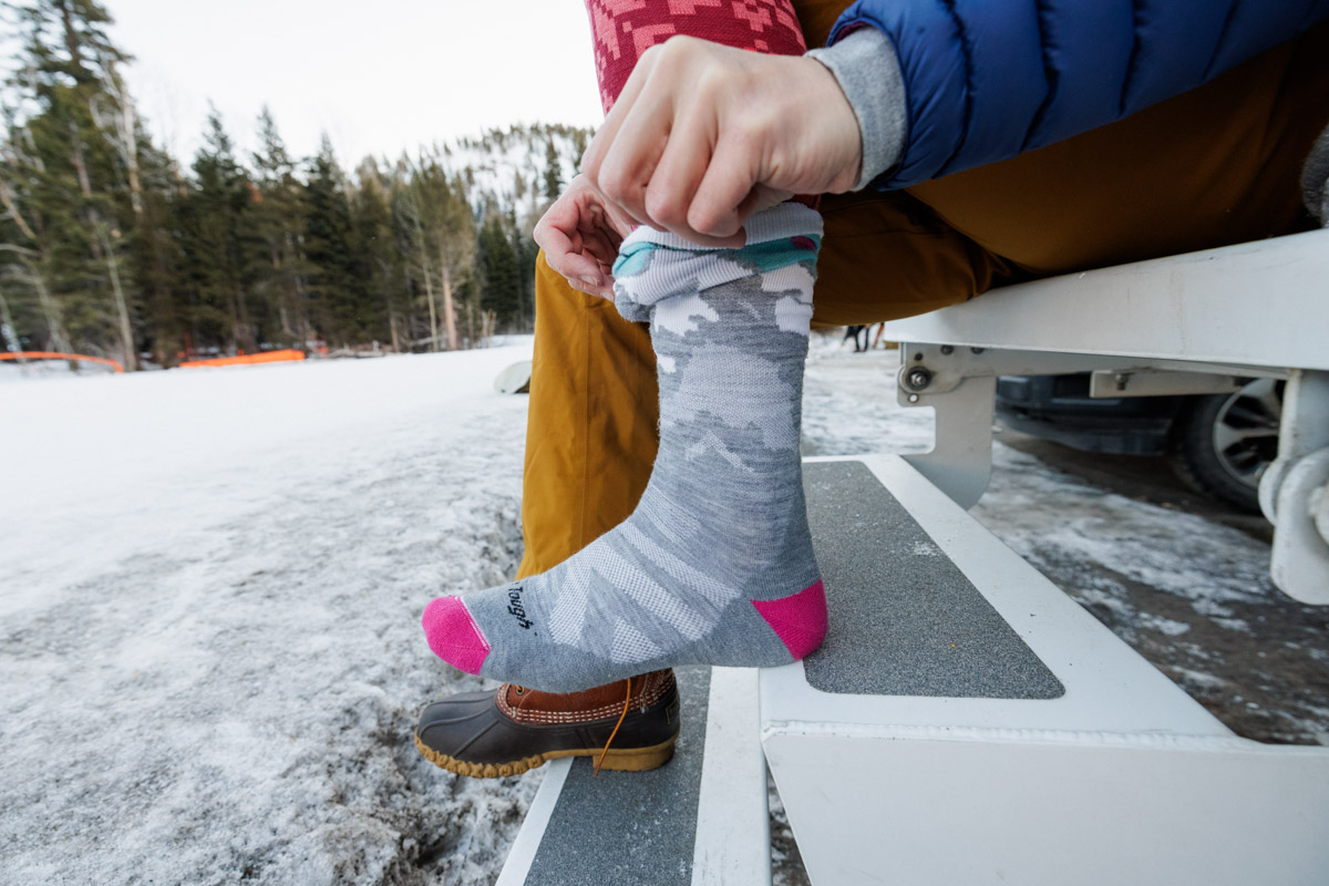 Pulling on a pair of ski socks