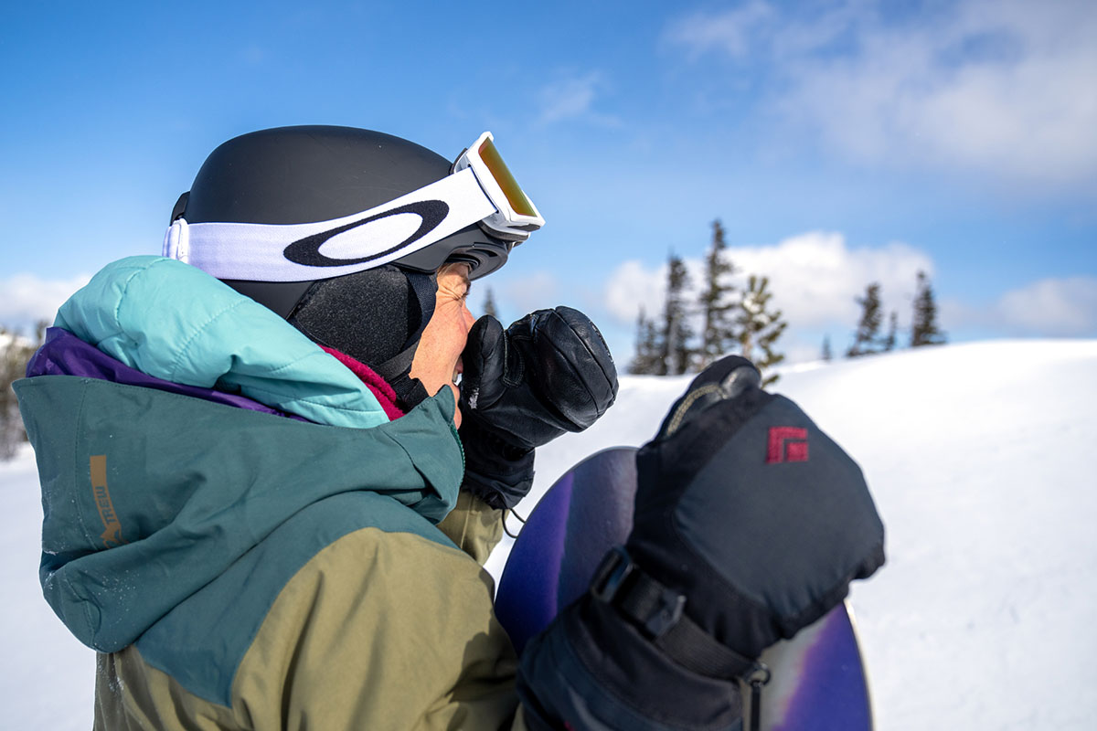 A skiier demonstrates how a hood can get in the way of her outer shell.