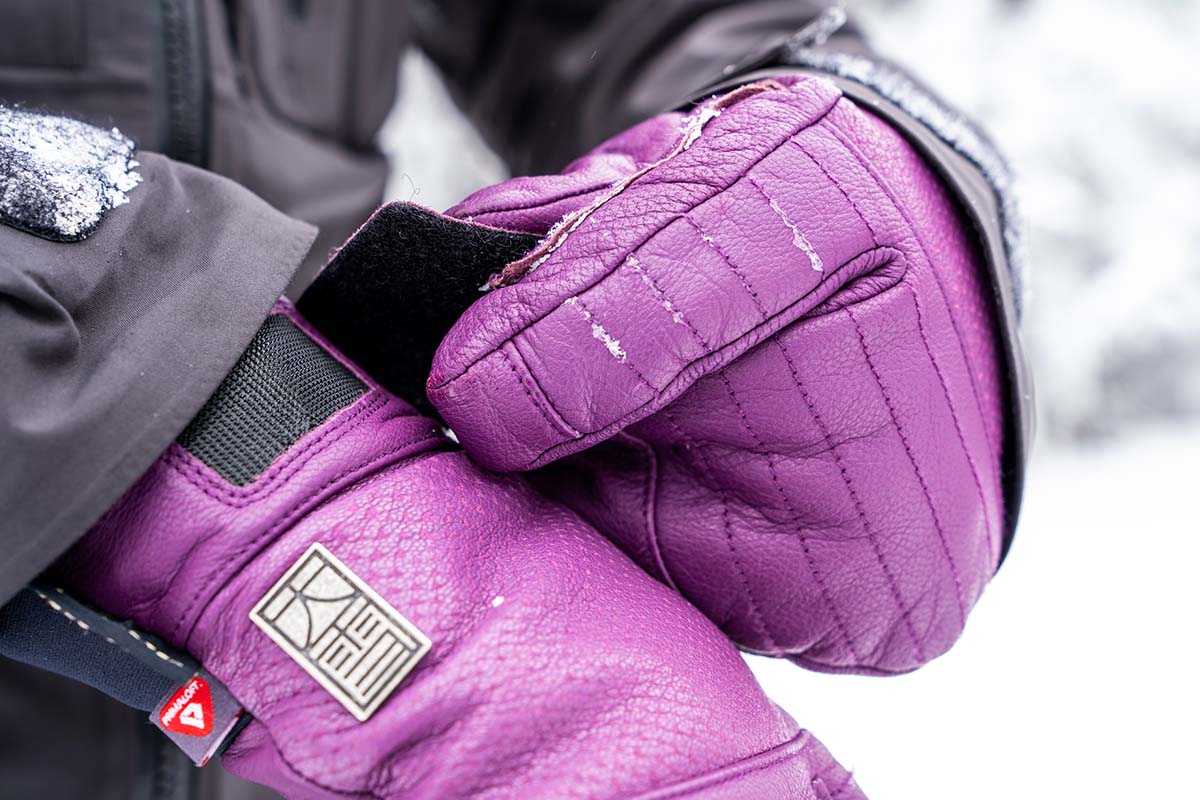 A close up of purple 3-finger ski gloves