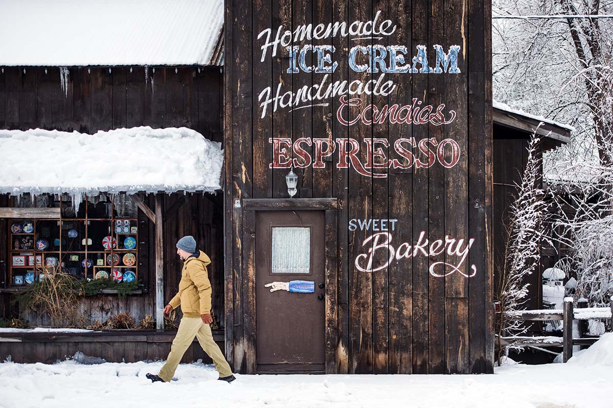 A man walks around town on a snowy day
