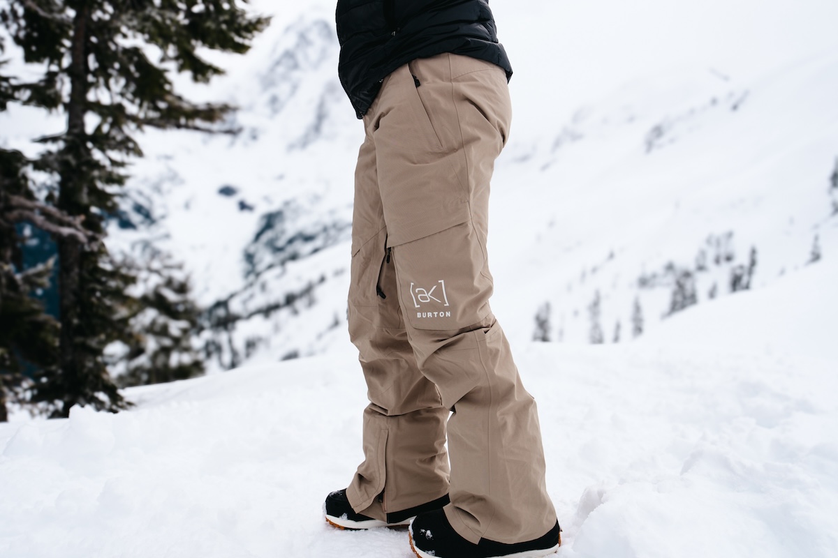 A snowboarder standing in the snow, showing the women's burton pants