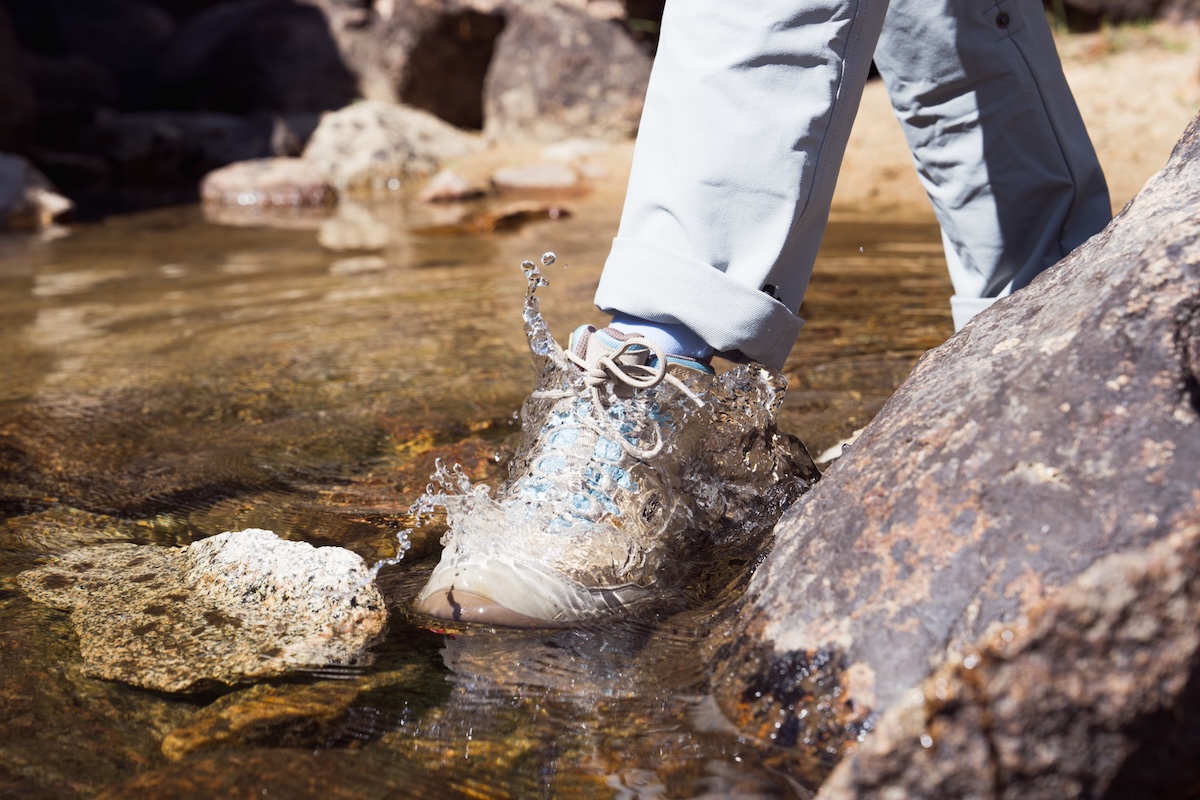 A closeup of waterproof shoes in a river