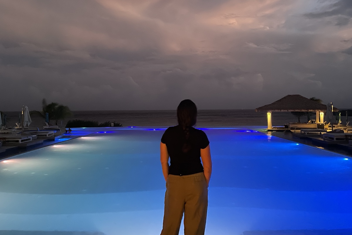 Looking out over a pool in Curacao in the Athleta Retreat linen pants