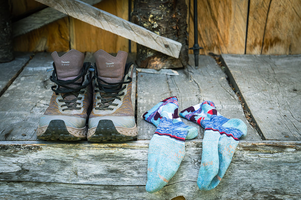 Nnormal boots set upon a cabin deck after a long day hiking.