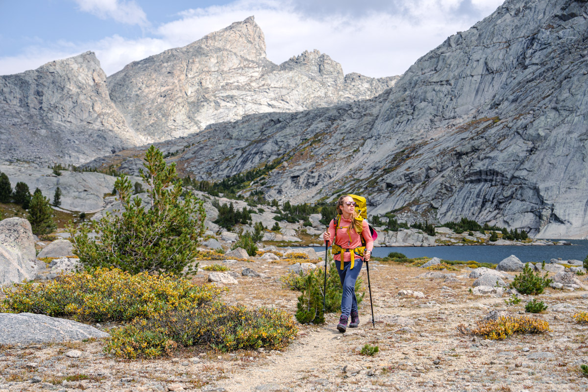 A backpacker enjoys a sunny afternoon on the trial while hiking to her next camp.