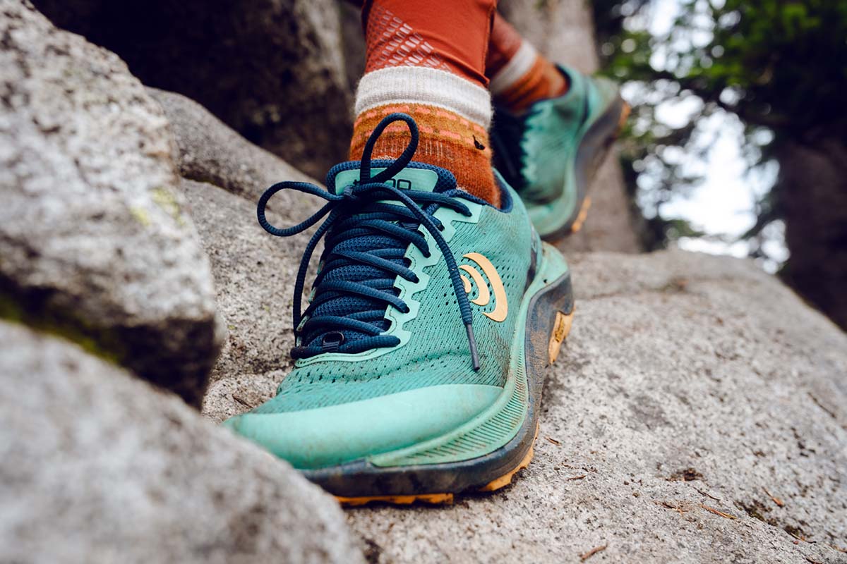 Women's hiking shoes shown, with the Topo Athletic Ultraventure on rock