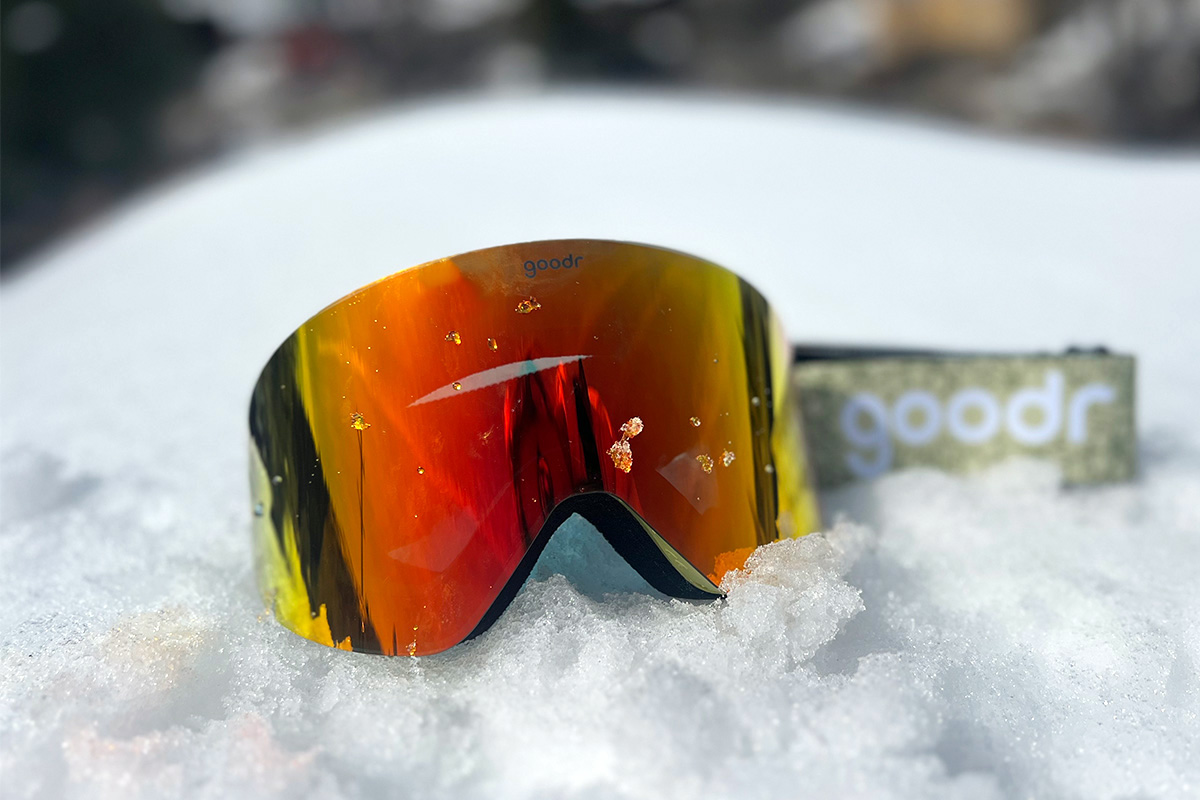 A pair of goggles lies in the snow