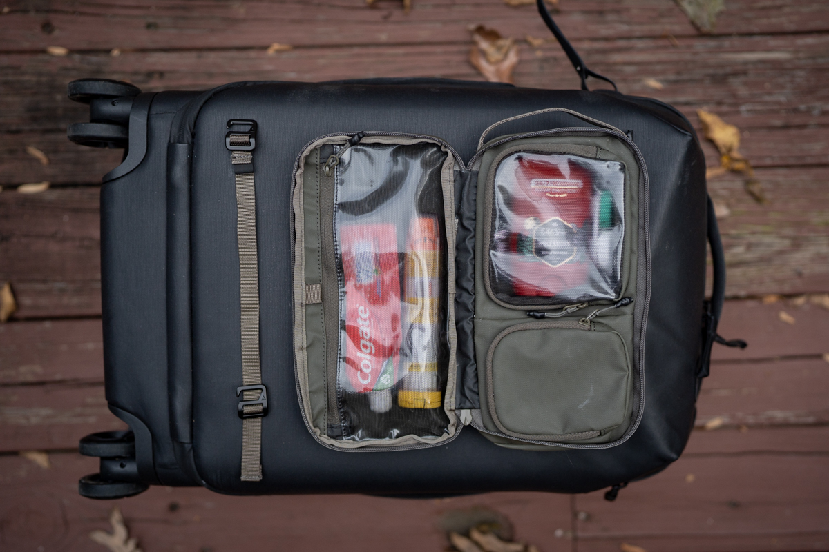 A toiletry bag is laid out, featuring all of its contents.