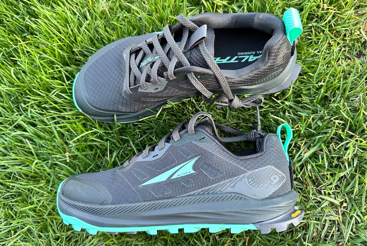 A pair of Altra Lone Peak 9 shoes lying in the grass showing the upgraded version