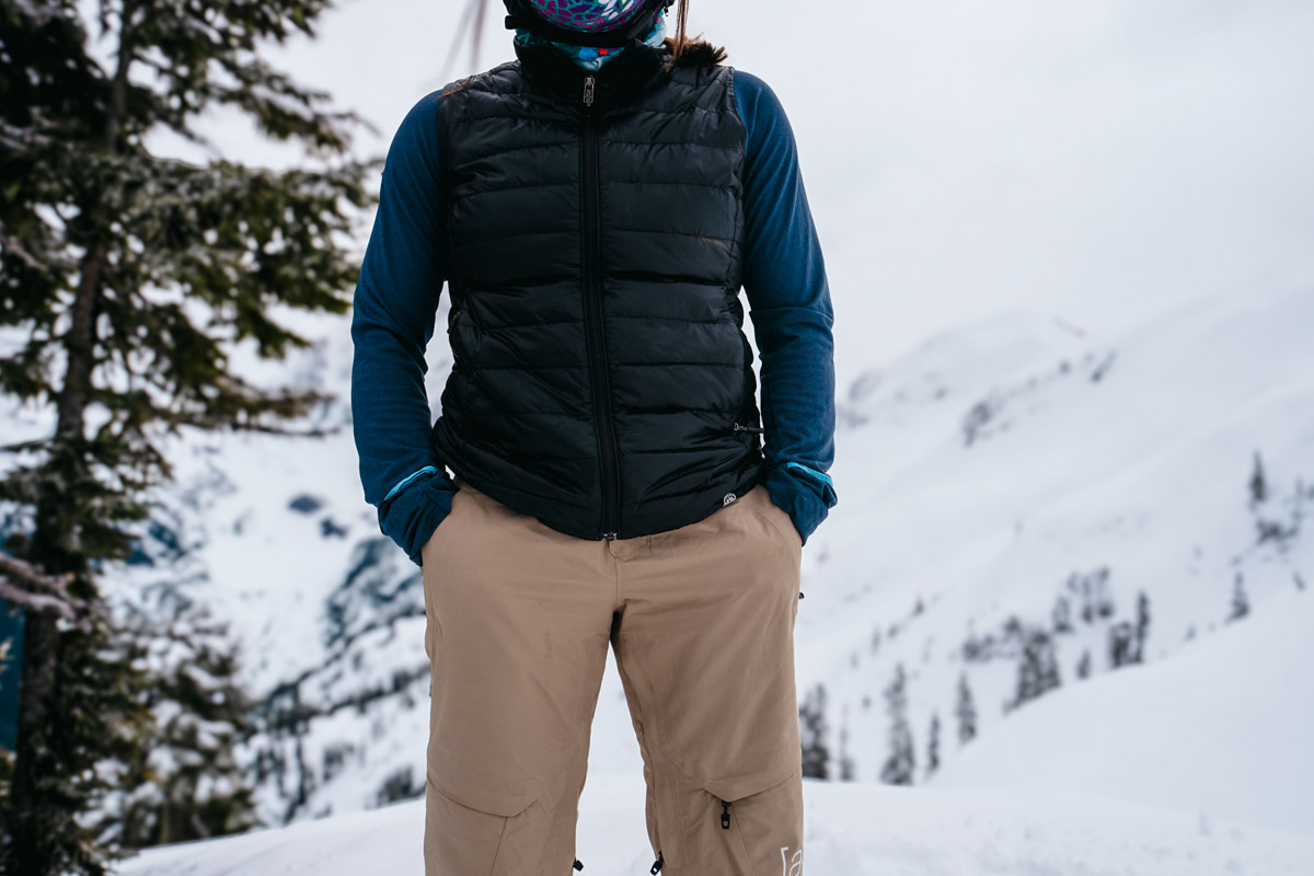 A woman with her hands in the pockets of her snowboard pants