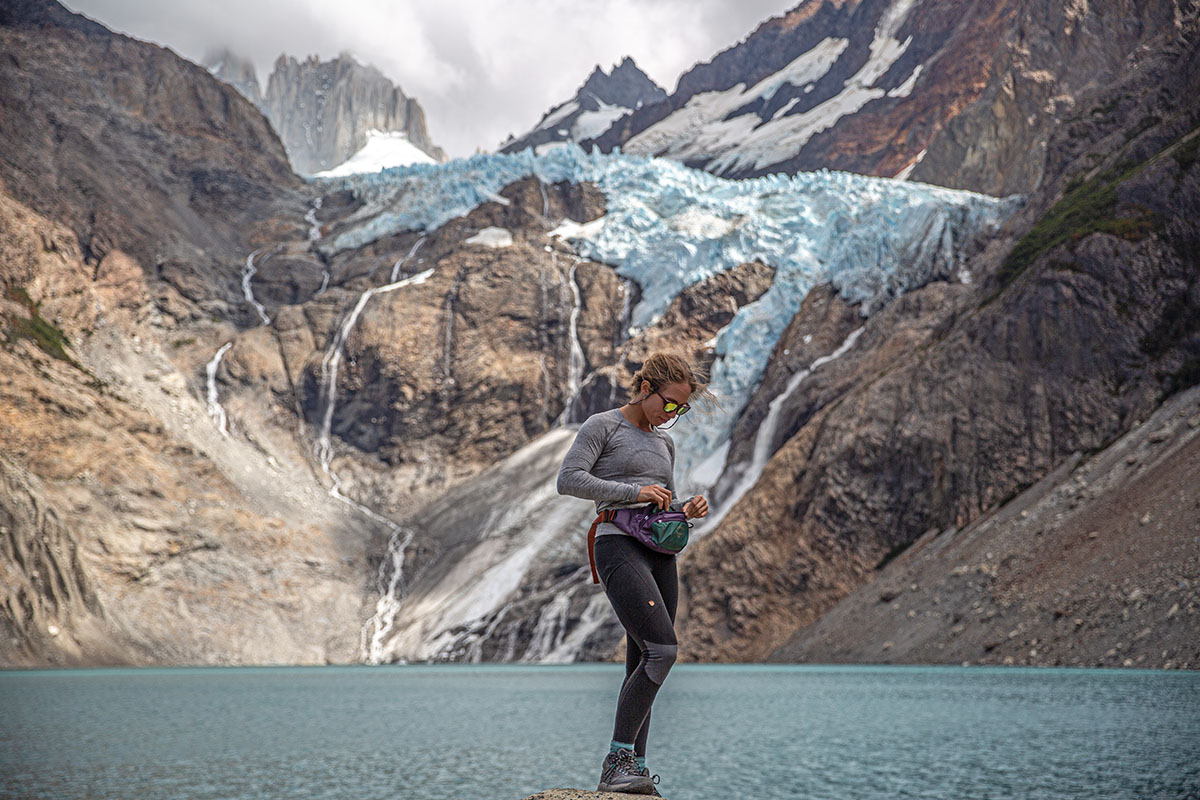 KEEN NXIS EVO WP hiking boots (reaching into waist pack)