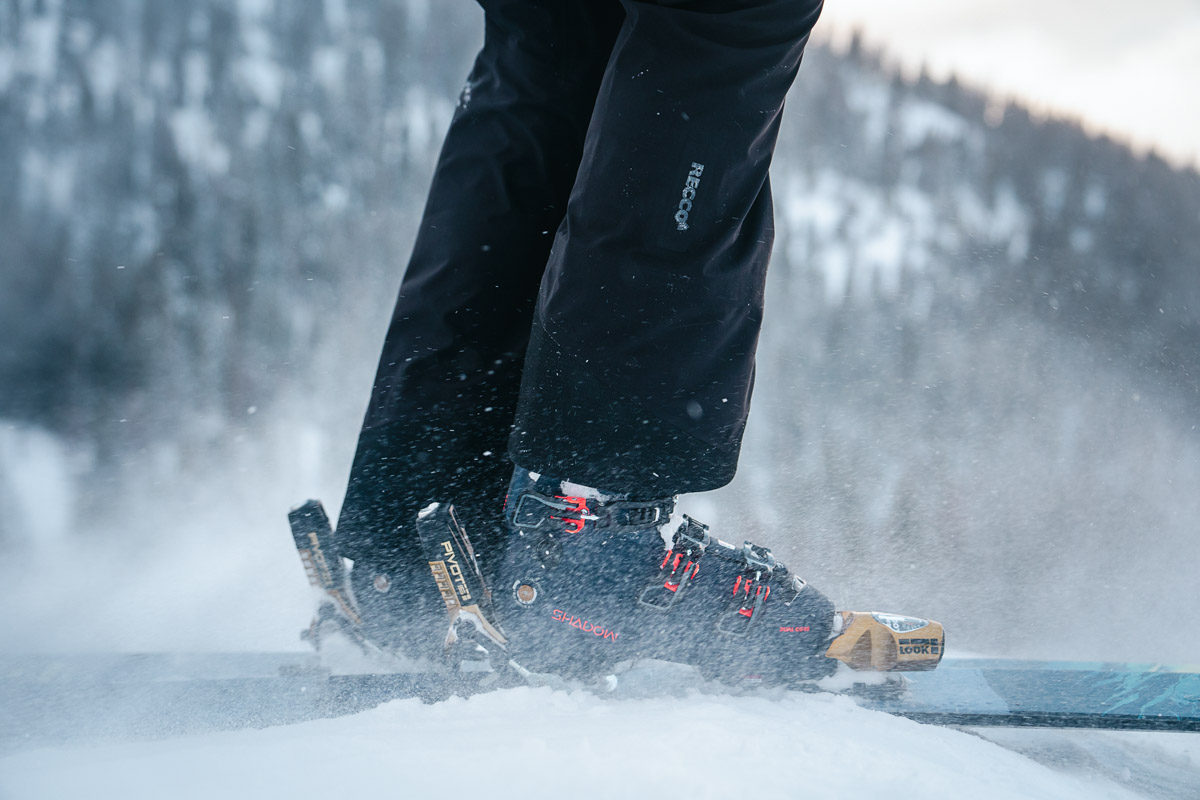 Snow blowing over a pair of ski boot