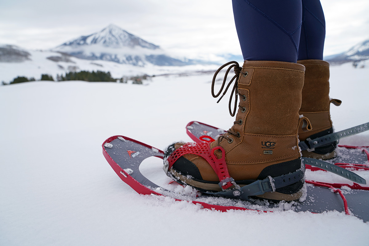 Close up of winter boots strapped to snowshoes