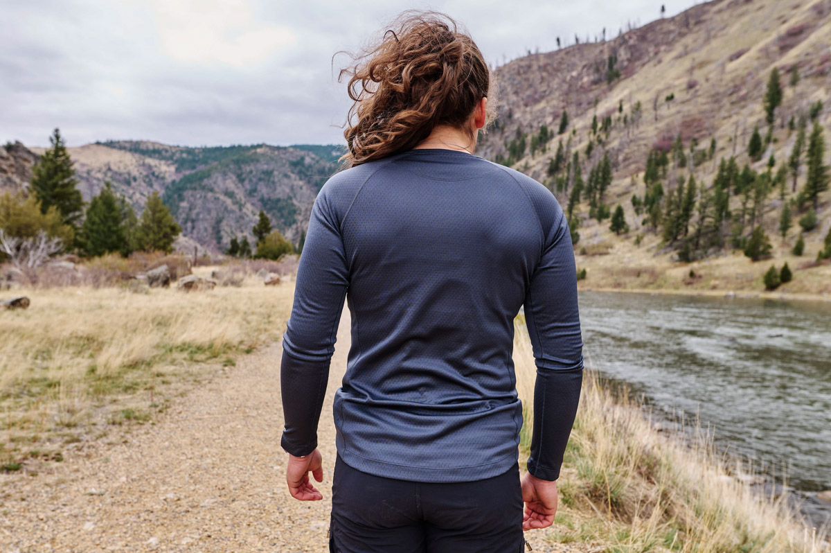 A woman showing the Patagonia Capilene Midweight shirt from behind, where it is a bit tight across her shoulder blades