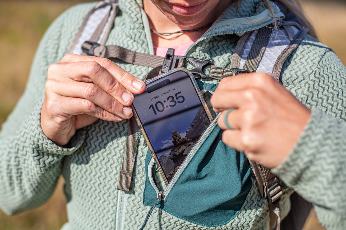 Pulling the phone out of the chest pocket of a fleece