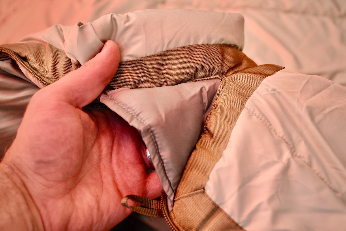 Showing the anti-snag zipper lining on the REI Co-op Siesta Hooded 20 Sleeping Bag