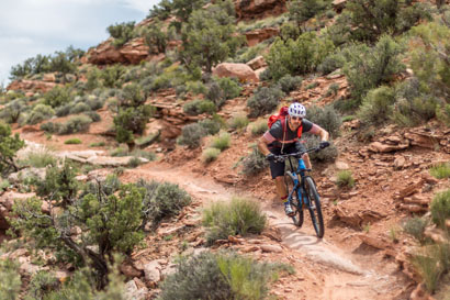 Brian McCurdy bombing down a hill on a mountain bike
