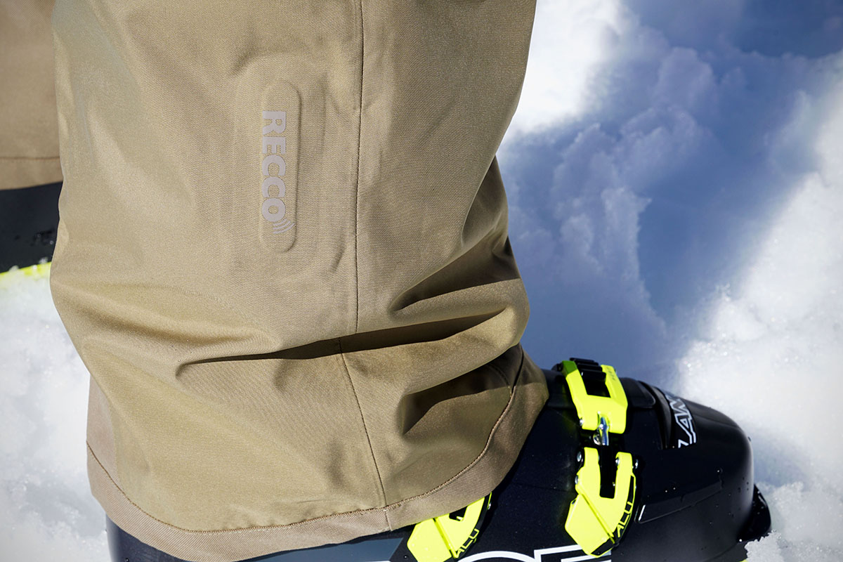 A close-up image of the Recco technology logo on the bottom leg of a ski pant