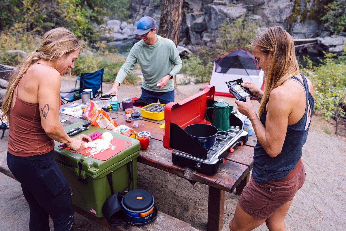 The Switchback team prepping a meal at a picnic table