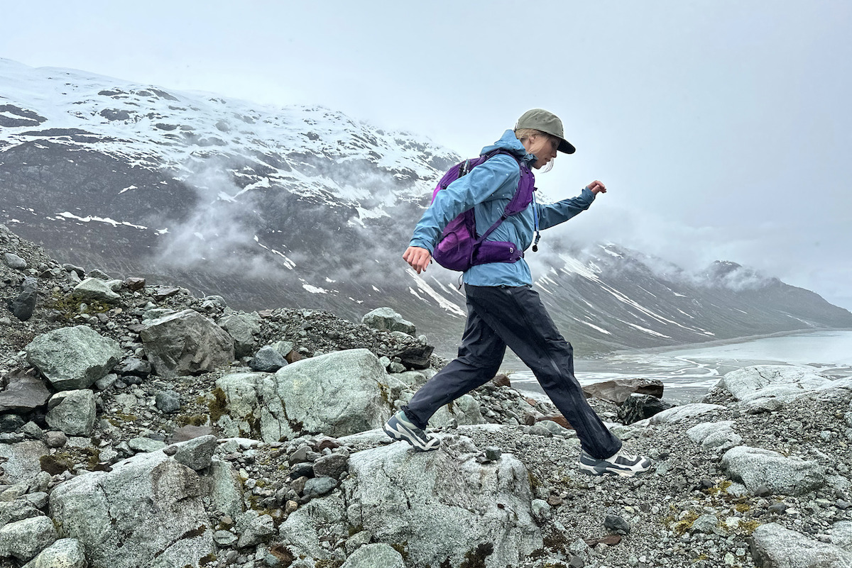 A women hiking in Alaska in the REI Co-op XeroCloud 3L jacket